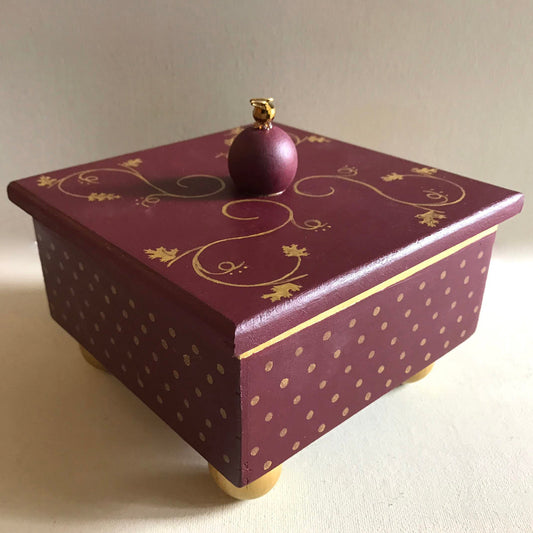 Gold leaf decorative handmade wooden box with metallic gold details.